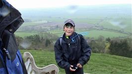 James offers chocolate eclairs all round while climbing the many steps to reach the top of Glastonbury Tor
